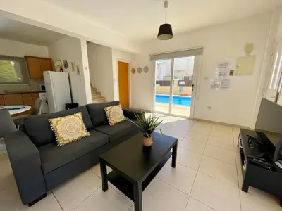 a living room with a couch and a table at Villa Scarlett, Ayia Thekla in Ayia Napa