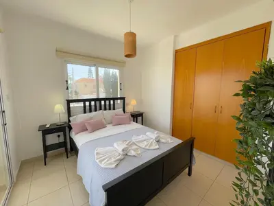 a bedroom with a bed with towels on it at Villa Scarlett, Ayia Thekla in Ayia Napa