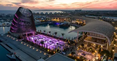 a view of a building with a marina at night at Villa Scarlett, Ayia Thekla in Ayia Napa