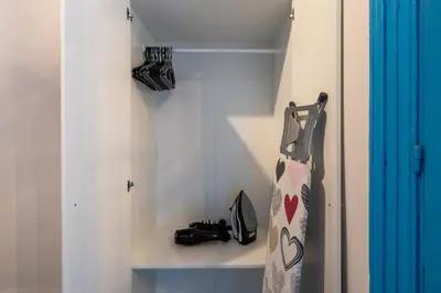 a closet with a shelf with shoes and a racket at Blue Haven - 2-BR Artistic Escape in Larnaca in Larnaka