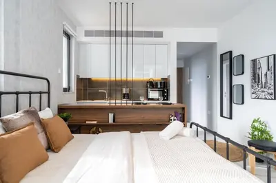 a bedroom with a large white bed and a kitchen at Dusk - Harmonic Studio by Plus 49 in Mackenzie in Larnaka