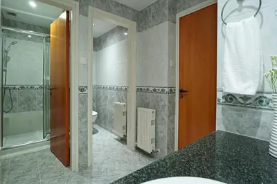 a bathroom with a shower and a toilet and a sink at Nissi Diamond Mansion in Ayia Napa