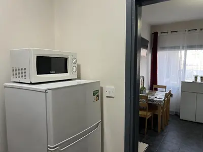 a microwave on top of a refrigerator in a kitchen at two-room apartment center in Limassol