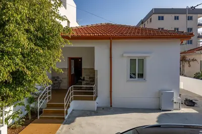 a small white house with a porch and stairs at Olga Premium Apartments in Limassol