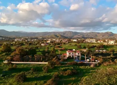 an aerial view of a town with mountains in the background at White Cove Villa, Limassol in Pyrgos