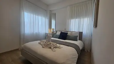 a bedroom with a large bed with white curtains at STAY City Center Gem in Nicosia