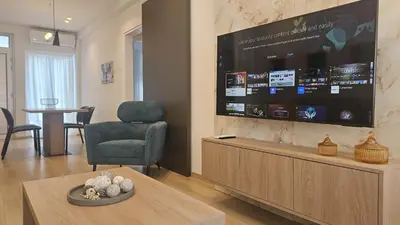 a living room with a large flat screen tv at STAY City Center Gem in Nicosia