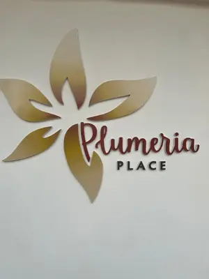 a logo for a philippine place with a flower at Plumeria Place Bright and spacious studio in Larnaka