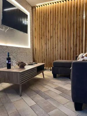 a living room with a couch and a table at Plumeria Place Bright and spacious studio in Larnaka