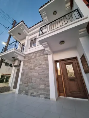 a house with a wooden door and a balcony at Jacobs home in Larnaka