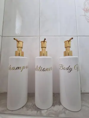 three bottles ofodorizers sitting on a counter in a bathroom at Jacobs home in Larnaka