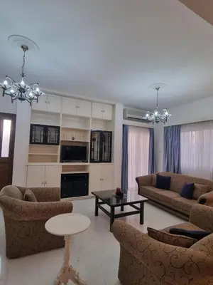 a living room with two couches and a table at Jacobs home in Larnaka