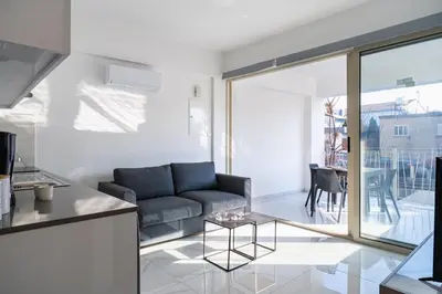 a living room with a couch and a table at Marble - Cozy Studio W Balcony in Larnaca in Larnaka