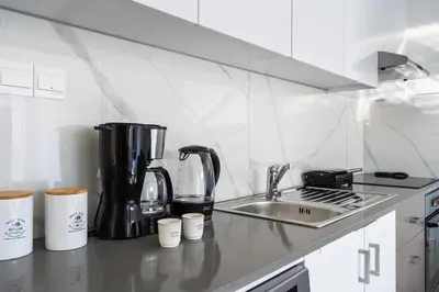 a kitchen with a counter top with a coffee maker at Marble - Cozy Studio W Balcony in Larnaca in Larnaka