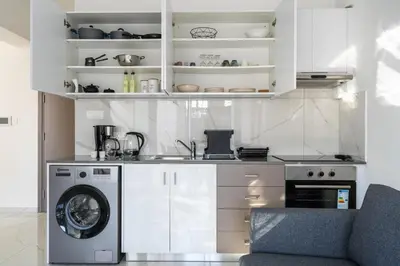 a kitchen with a washer and a washing machine at Marble - Cozy Studio W Balcony in Larnaca in Larnaka
