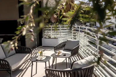 a patio with chairs and tables on a balcony at Elysium Heights in Nicosia