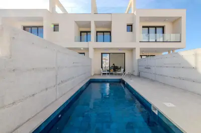 a house with a swimming pool in front of a house at Quattro Rise in Paralimni