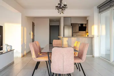 a dining room with a table and some chairs at Penthouse Great View Hydromassage Penthouse hottub in Limassol