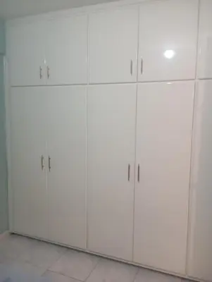a group of white cabinets in a room at Eat well Sleep Well in Larnaka