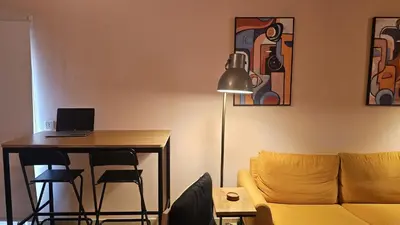 a living room with a couch and a table with a laptop at STAY Velvet Apartment in Limassol
