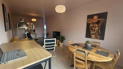 a dining room with a table and a laptop on it at STAY Velvet Apartment in Limassol