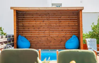 two blue vases sitting next to a swimming pool at Perle Di Gio in Larnaka