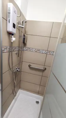 a shower in a bathroom with a hand dryer at FLH - Feel Like Home Modern 1-Bedroom Ground floor Apartment in Strovolos in Kato Lakatamia