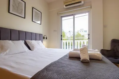 a bedroom with a bed and a large window at Central & Peaceful Nicosia 2BR in Nicosia