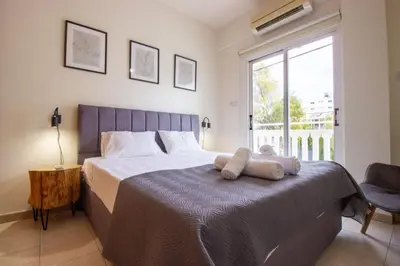 a bedroom with a bed with two towels on it at Central & Peaceful Nicosia 2BR in Nicosia