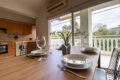 a dining room with a table with plates on it at Central & Peaceful Nicosia 2BR in Nicosia