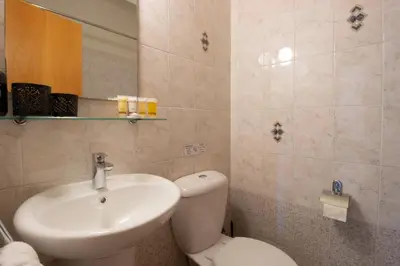 a bathroom with a white toilet and a sink at Central & Peaceful Nicosia 2BR in Nicosia