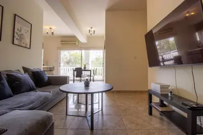 a living room with a couch and a table at Central & Peaceful Nicosia 2BR in Nicosia