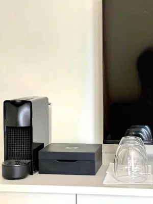 a microwave sitting on a counter next to a glass appliance at The Colonial in Larnaka