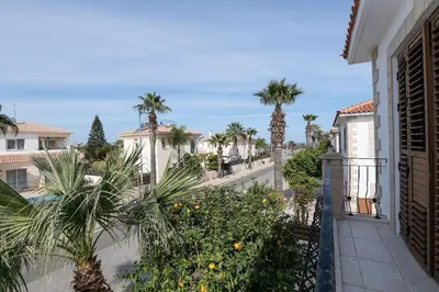 a balcony view of a street with palm trees at Malama 28 Villa Ekaterina in Paralimni