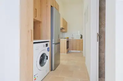 a kitchen with a washer and dryer at Lito - Slow Living in Larnaka
