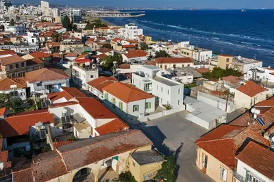 an aerial view of a city with buildings and the ocean at Lito - Slow Living in Larnaka