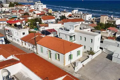 an aerial view of a city with houses and the ocean at Lito - Slow Living in Larnaka