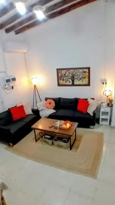 a living room with a couch and a coffee table at En Sylikion cottage in Silikou