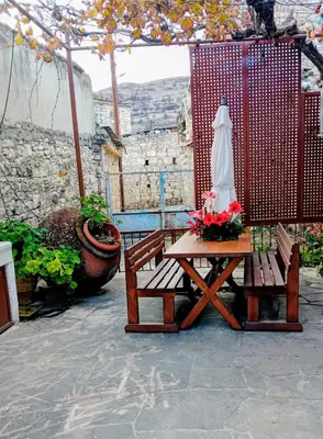 a picnic table and an umbrella on a patio at En Sylikion cottage in Silikou