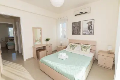 a bedroom with a bed with two towels on it at Pernera Gardens Villa Ekaterina in Protaras