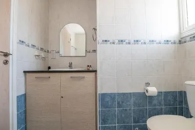 a bathroom with a sink and a toilet at Pernera Gardens Villa Ekaterina in Protaras