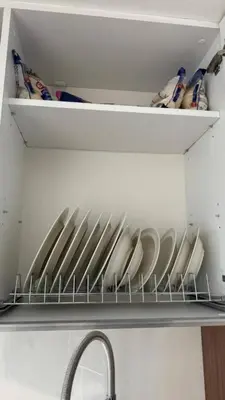 a kitchen shelf with plates and bowls in a refrigerator at Luxury Apartments with Sea View and Mountain View in Grand Sapphire Resort in Iskele