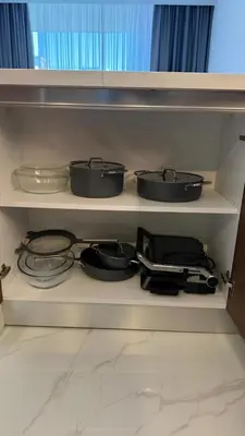 four pots and pans on a shelf in a kitchen at Luxury Apartments with Sea View and Mountain View in Grand Sapphire Resort in Iskele
