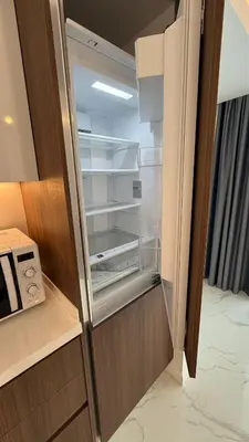 an empty refrigerator with its door open in a room at Luxury Apartments with Sea View and Mountain View in Grand Sapphire Resort in Iskele