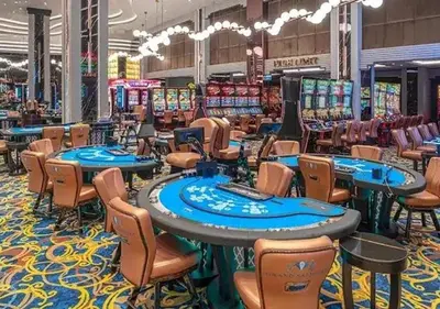 a casino with tables and chairs and poker machines at Luxury Apartments with Sea View and Mountain View in Grand Sapphire Resort in Iskele
