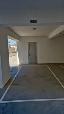 an empty parking lot with a door in a garage at New 1 bedroom flat in Aglatzia in Aglantzia
