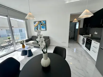 a living room with a vase of flowers on a table at New 1 bedroom flat in Aglatzia in Aglantzia