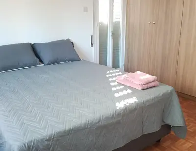 a bedroom with a bed with a pink towel on it at alfarome60 in Nicosia