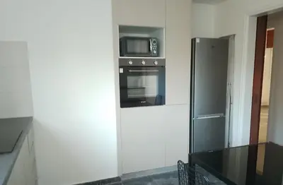 a kitchen with a refrigerator and a microwave at alfarome60 in Nicosia