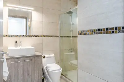 a bathroom with a toilet and a sink and a shower at Penthouse with outdoor hottub in Limassol